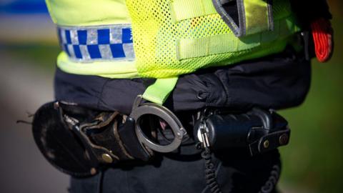 A stock image of a police officer's handcuffs.