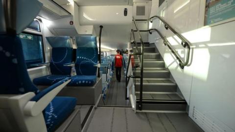 An employee of French State-owned rail operator SNCF is pictured inside a TER Regio 2N (Regio2N) train on September 15, 2014 at the St-Jean train station in Bordeaux, South-western France.