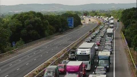 A traffic jam on the M5 in Somerset. One side of the motorway is clear, while the other is congested.