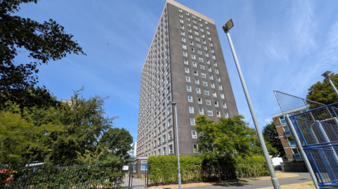 Edgbaston House seen from street level. The grey, rectangular tower block appears to have 17 storeys.