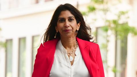 Suella Braverman MP in a red blazer