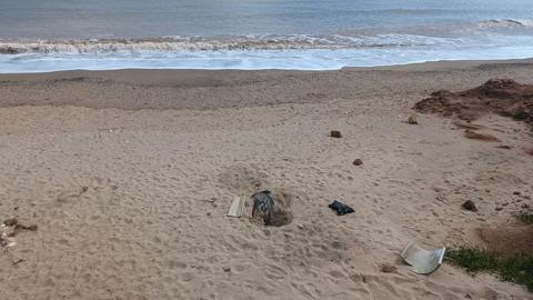 Hollym beach where the body was found there is a hole in the middle of the picture with a black blanket in it 