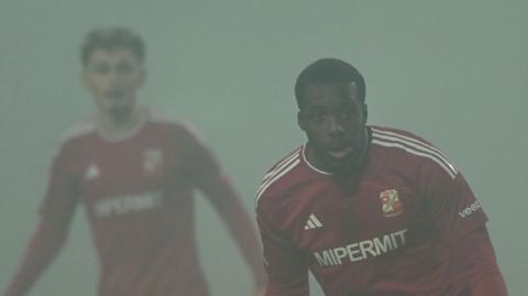 Swindon's Nnamdi Ofoborh in the fog against Crewe