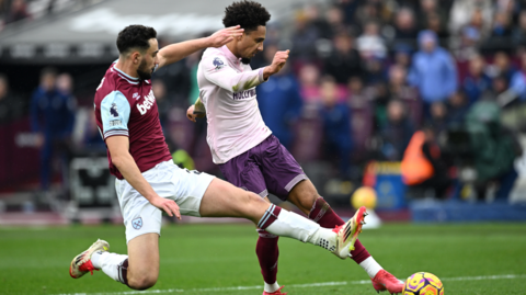 Kevin Schade of Brentford battles for possession with Max Kilman of West Ham United