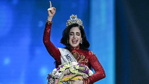 Miss Universe Fatima Bosch from Mexico pointing to the sky after her crowning