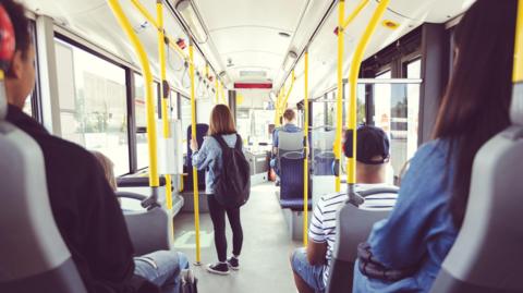 
Males and females commuting by public transport - stock photo
Men and women traveling in public transport. Teenage girl is standing at aisle while commuting by bus. They are in vehicle.