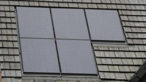 A picture of two solar panels on top of the roof. It is navy blue in colour with stripes.