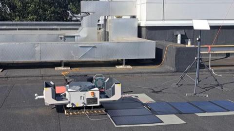 Drone taking off from its housing on rooftop