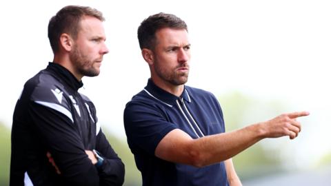 Oxford United Manager Aaron Ramsey (right) and assistant Chris Gunter.