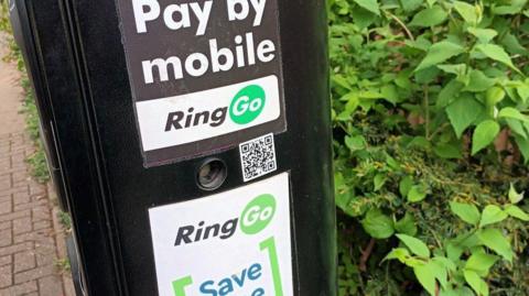 A RingGo parking machine that has a small QR code in the middle. 
