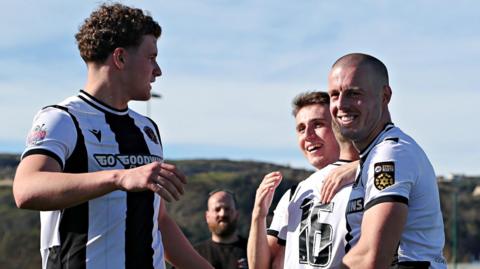 Llandudno players celebrate after securing the JD Cymru Premier title