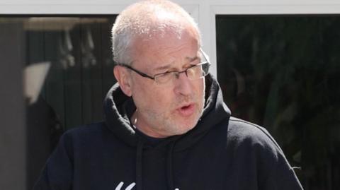 man in glasses and black hoody