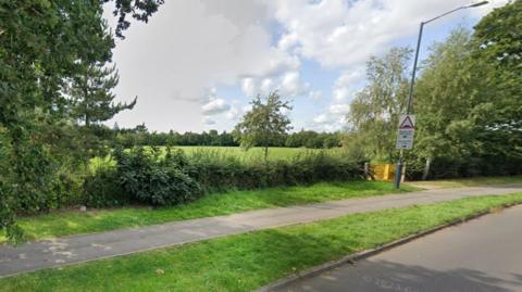 A generic image of Lower Hillmorton Road, including trees and grass in the background 