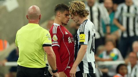 Newcastle's Anthony Gordon, who was sent of for a foul on Virgil van Dijk, squares up to Liverpool's Milos Kerkez
