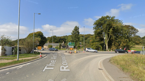 A view of the roundabout taken from the roof of a car. An exit can be seen to the left.