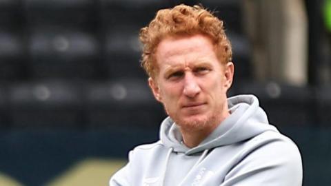 Dean Lewington, wearing a hoodie