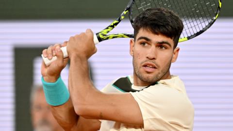 Carlos Alcaraz hits a backhand