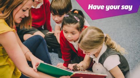 Young children looking at a book with a teacher.