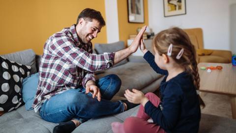 A father and daughter act out a nursery rhyme.