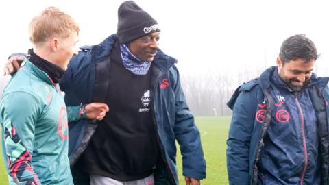Snoop Dogg with player and coach at Swansea training