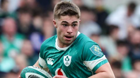 Jack Crowley runs with the ball during Ireland's loss to France