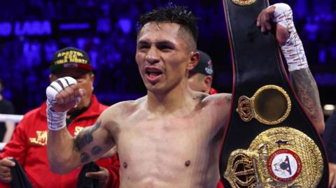 Mauricio Lara celebrates with his WBA title