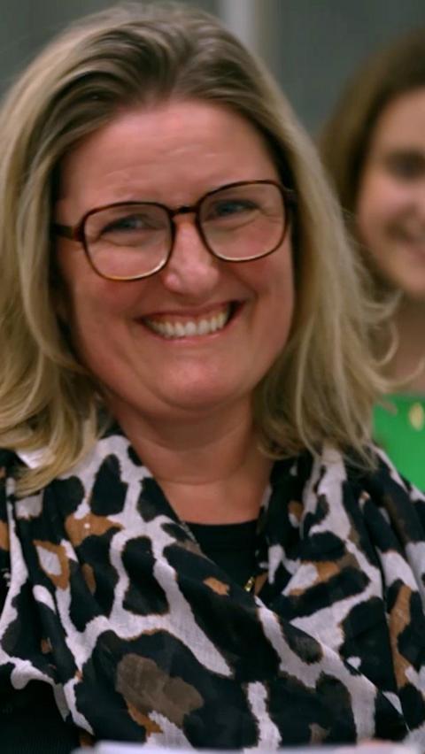 Woman  wearing glasses smiles at the camera
