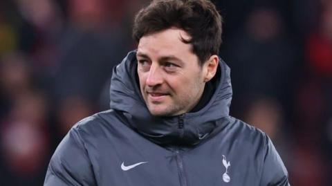 Ryan Mason in his grey Tottenham training top looks on during a pre-match warm up