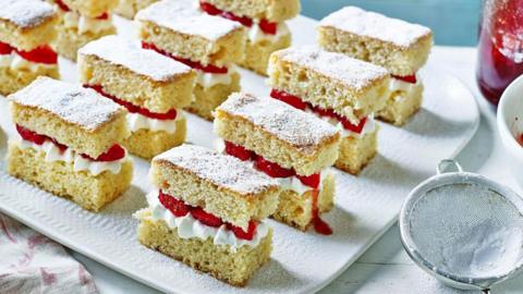 A plate of strawberry cake slices.
