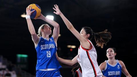Scotland's Ella Doherty jumping against Singapore's Hor Ying Matilda Lai
