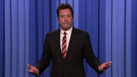 Jimmy Fallon holding his hands up mid-speaking
