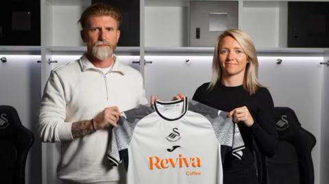 New Swansea City Women boss Jamie Sherwood and head of women's football Alice Weekes hold up the club's shirt