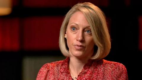 Claire Waxman, with blonde chin length hair in a bob, wearing a red blouse.