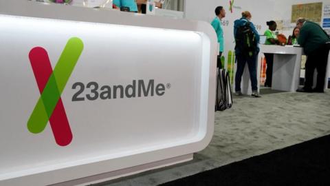 The 23andMe logo at a 2019 genealogy conference where the DNA testing company hosted a booth for attendees
