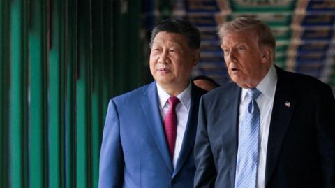 U.S. President Donald Trump looks on as he participates in a friendship walk through Zhongnanhai Garden with Chinese President Xi Jinping in Beijing, China