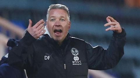 Peterborough boss Darren Ferguson throws his arms up in frustration on the touchline