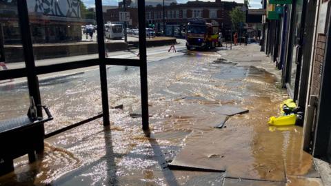 Water flows down Ipswich street.