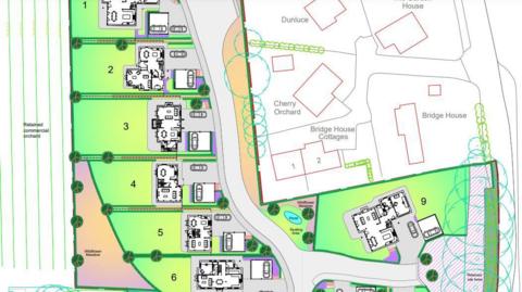 A map of the plans for the Suckley self-build homes. The images shows several plots where the houses would be built, the road in front of them, and existing village buildings nearby.