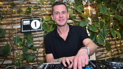 A 2019 file photo of Mills adjusting the levels on a DJ mixer while standing in front of a wall covered in ivy, at Radio 1's Big Weekend launch party, at Shoreditch House in London.