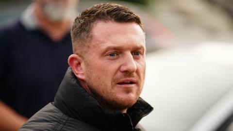 Headshot of Stephen Yaxley-Lennon in a black coat