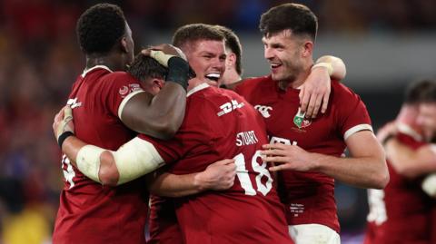 Lions players celebrate victory over Australia