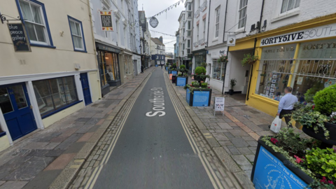 A google streetview image of Southside Street in Plymouth on the Barbican. It is a large long road with a number of businesses visible.