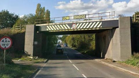 A bridge with a sign that reads "low bridge"