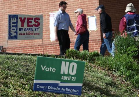 Voters arrive before casting their ballots at a polling location at the Westover Library on April 21, 2026 in Arlington, Virginia. 