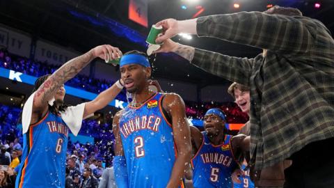 Shai Gilgeous-Alexander, of the Oklahoma City Thunder, gets drinks poured on him after the win against the Boston Celtics