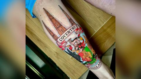 A tattoo featuring symbols of Coventry - including the three spires of Christ Church, Holy Trinity Church, and St Michael's Cathedral and the Coventry City FC coat of arms.