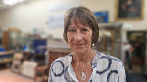 A head and shoulders photo of Bridget Pitcher, who is wearing a necklace and white shirt.
