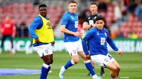 Ipswich players warm up at St Mary's