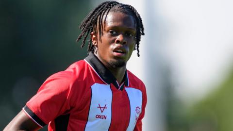 Zane Okoro in action for Lincoln City in a pre-season friendly