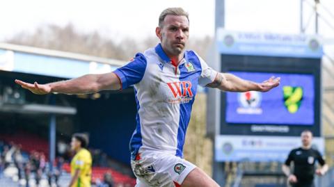 Andreas Weimann holds his arms out in celebration after scoring for Blackburn